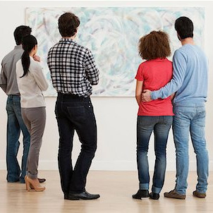 A group of people looking at art.