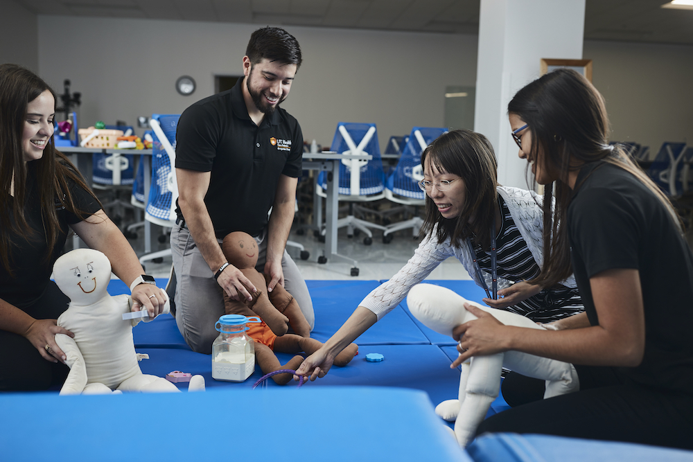 Occupational therapy students and professor practice skills