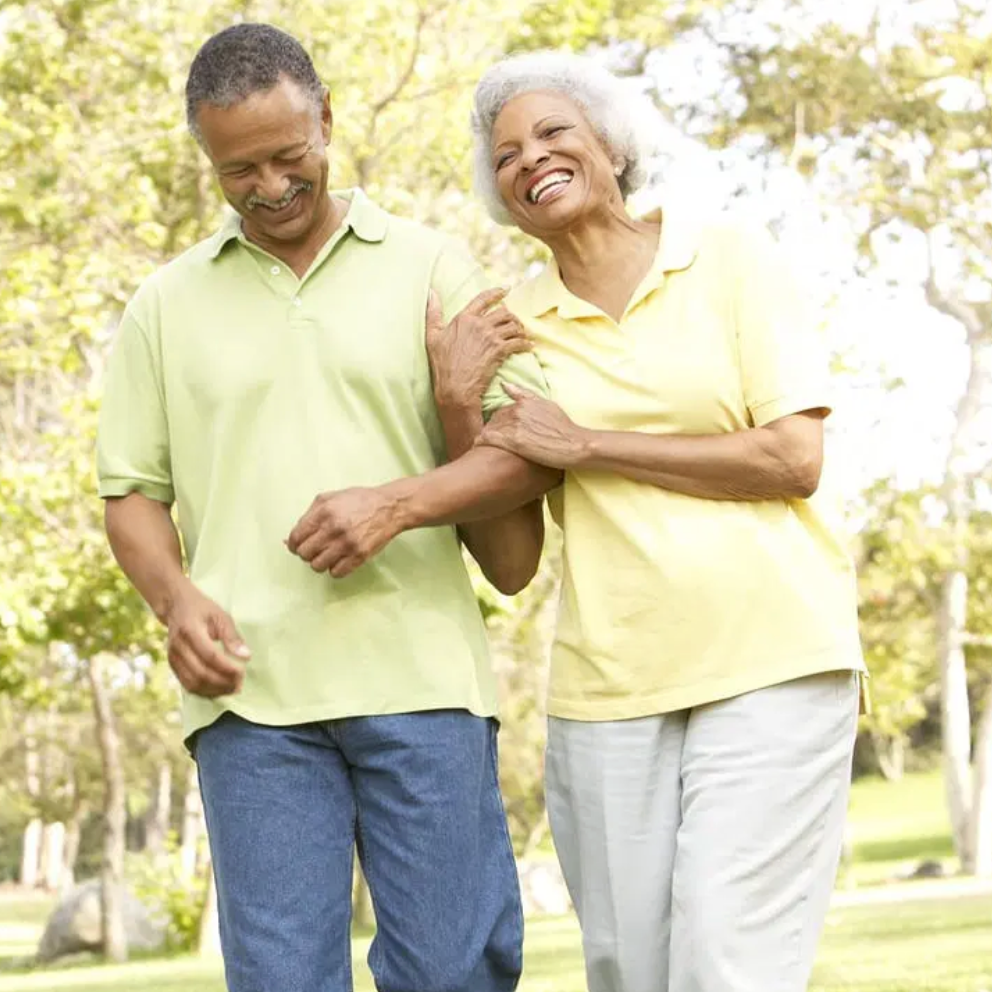 Photo of older couple walking arm in arm